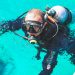 A young man is diving. Swims in a diving suit. Extreme sport. Diving.