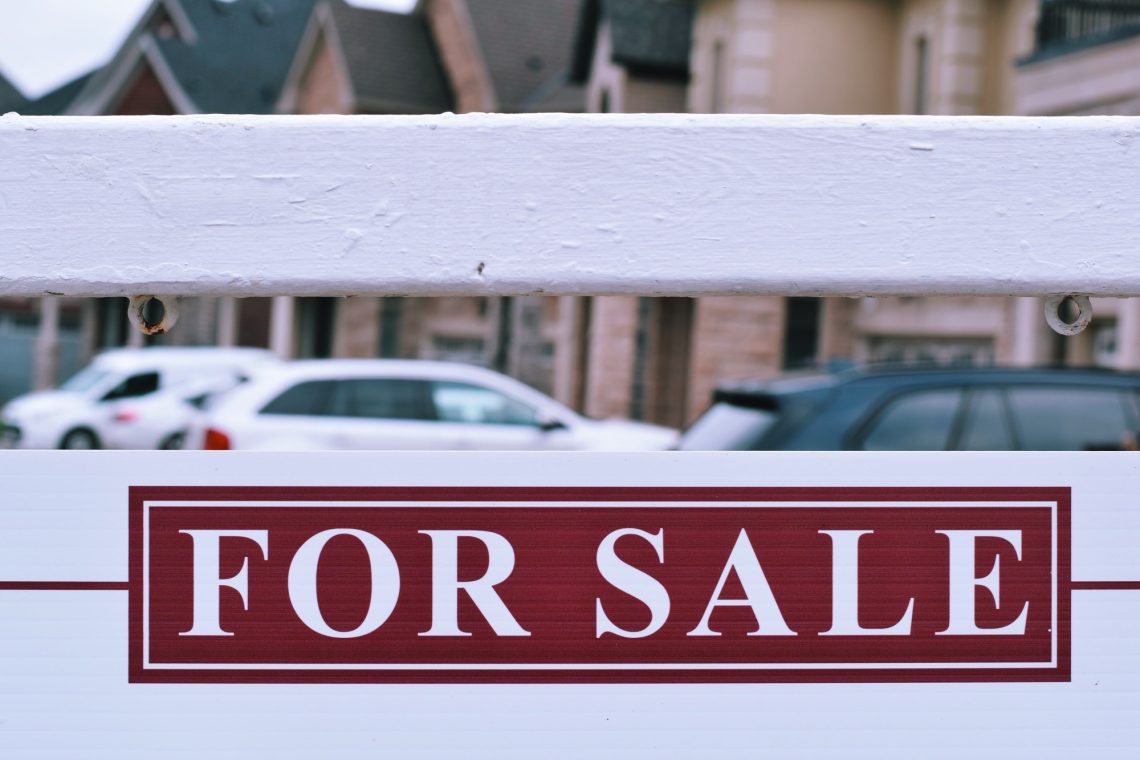 House for sale sign on a street