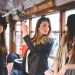 Three young women travelling on city tram